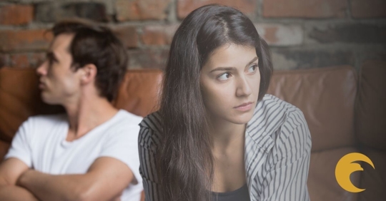 Woman and man sitting and looking away.