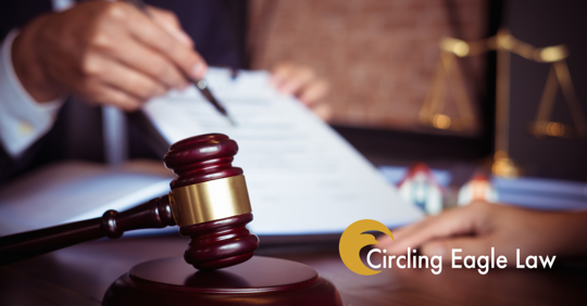 Gavel and a document signing in the background.