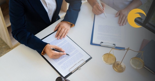 Two people looking over legal paperwork.
