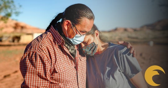 two native americans with masks on