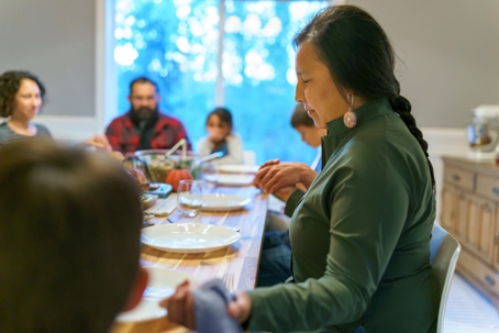 indigenous family gathered around the holiday table