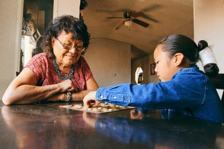 Grandmother and grandchild playing checkers