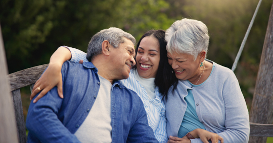 woman hugging elderly parents