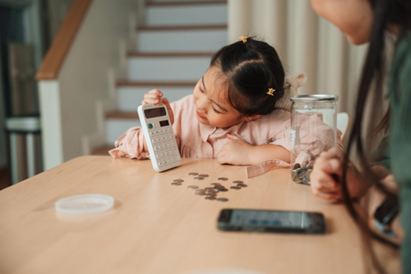 mother and daughter calculating budget