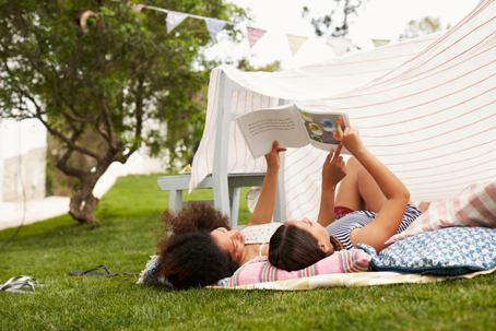 mother and daughter reading outside