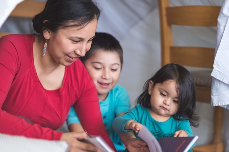 Mother reading to her two children
